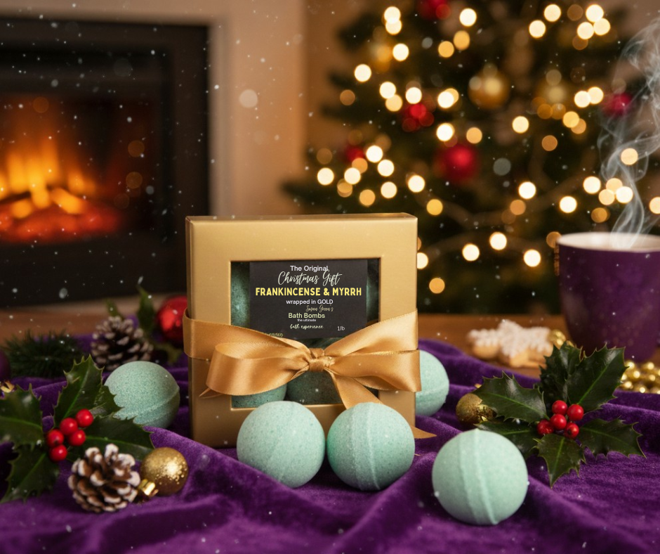 Gift box with bath bombs in front of a Christmas tree and fireplace